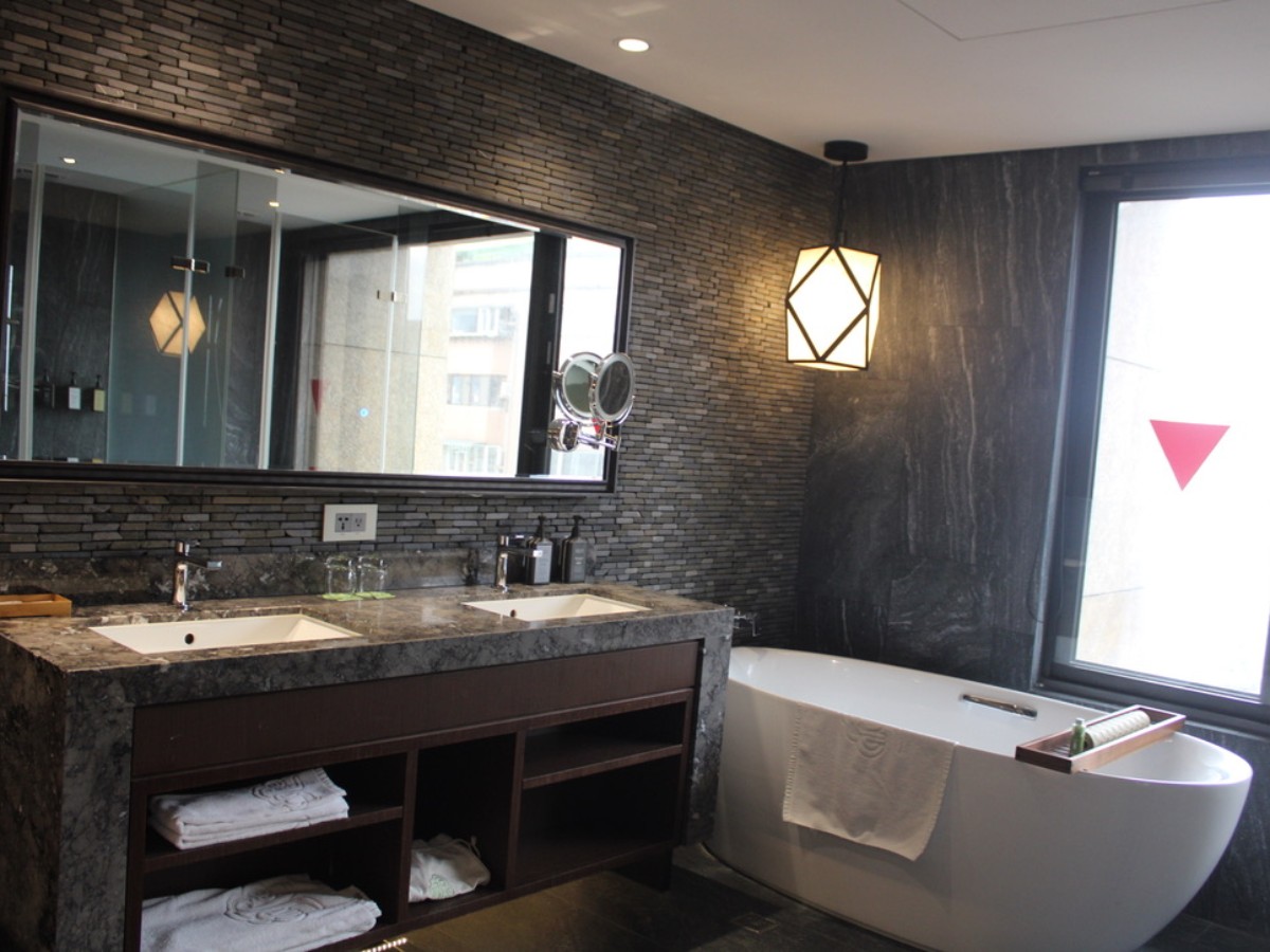 View of the mirrors and bathtub area at arTree Hotel