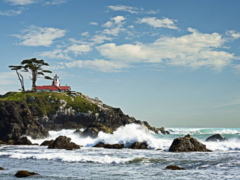 View of the Battery Point Lighthouse on the rocky cliff and the waves crashing below