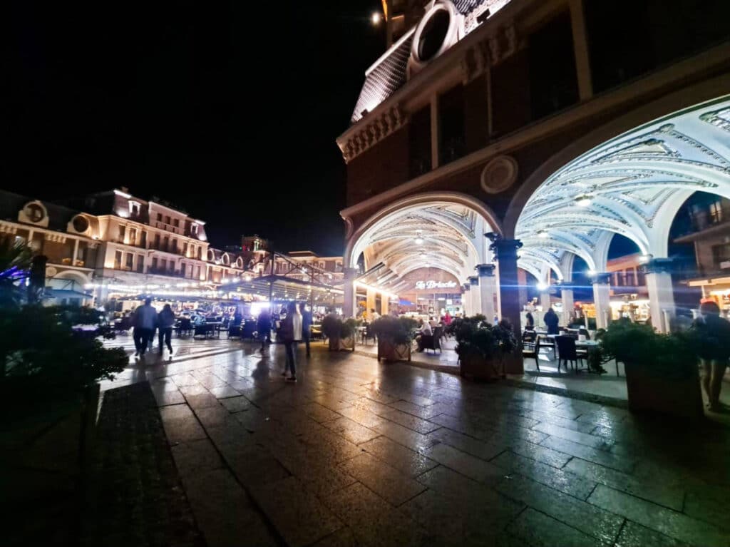 View of the crowd and fine architecture in Batumi Piazza at night