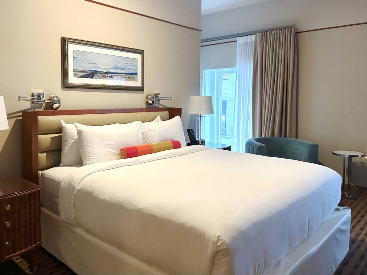 The huge bed and the interior of the hotel room in The Crawford Hotel