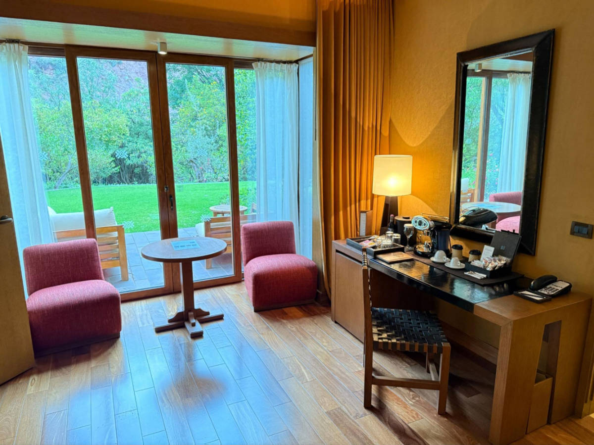 The other half of our bedroom featured a desk, coffee machine, mini bar, seating area, and blackout blinds