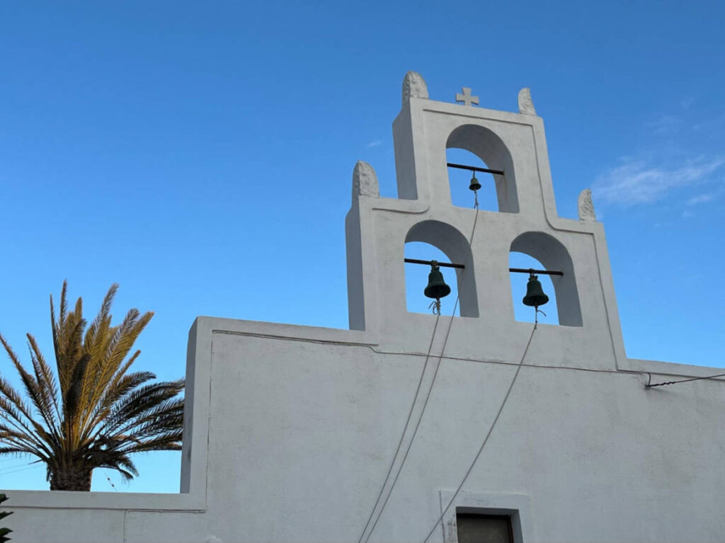 Perspective view of the Three Bells and the clear blue sky in Megalochori