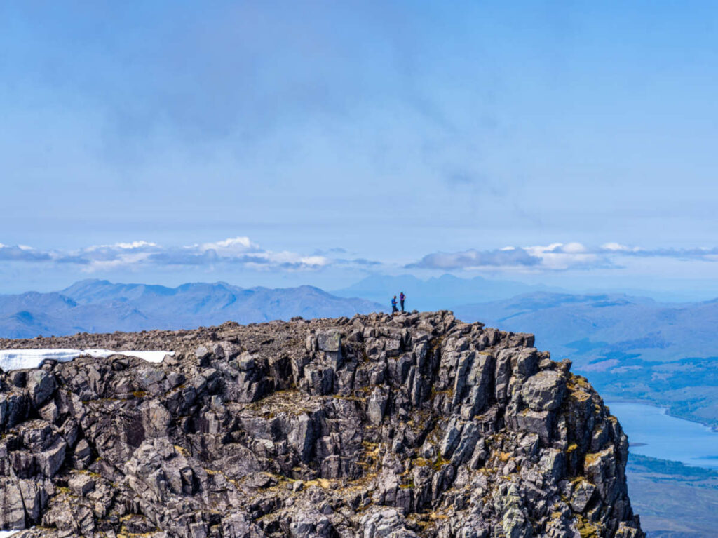 Two people on the rocky cliff of Ben Nevis