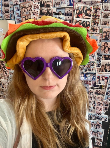 The author Bethan Nutting, wearing quirky accessories in a photobooth