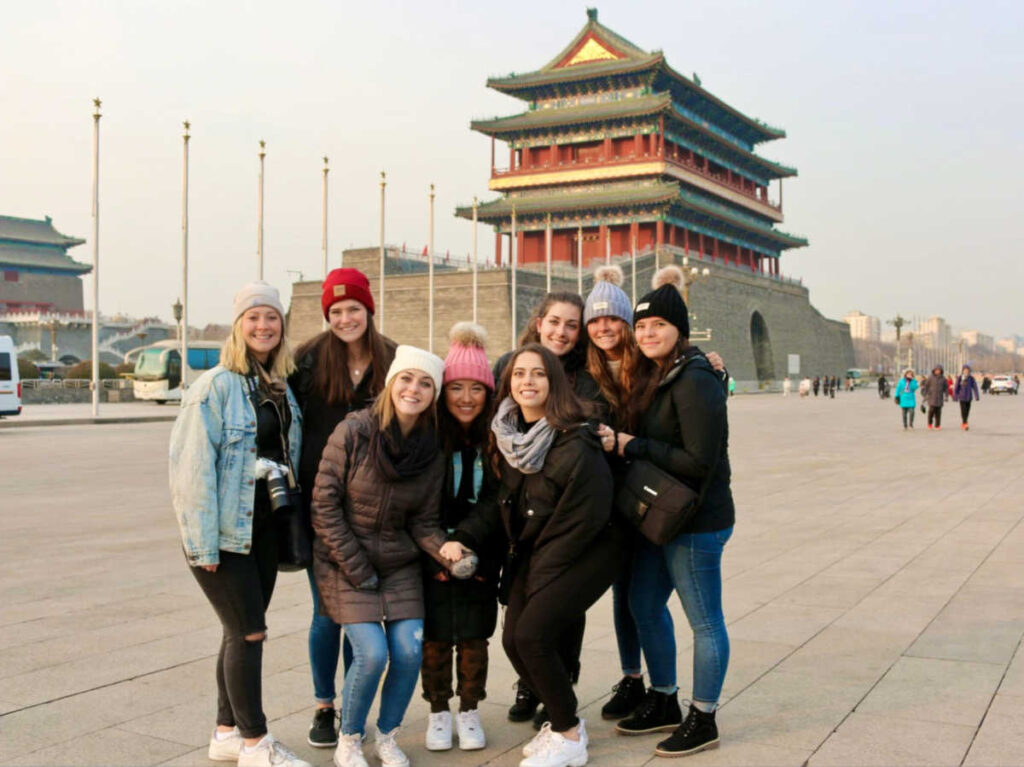 The author Betty Hurd and her friends outside Tiananmen Square at sunset