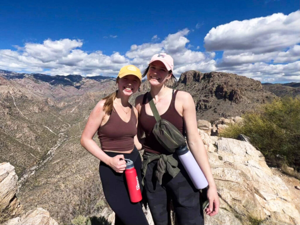 Travel Lemming Writer, Betty Hurd and her friend holding their water bottle on the trail