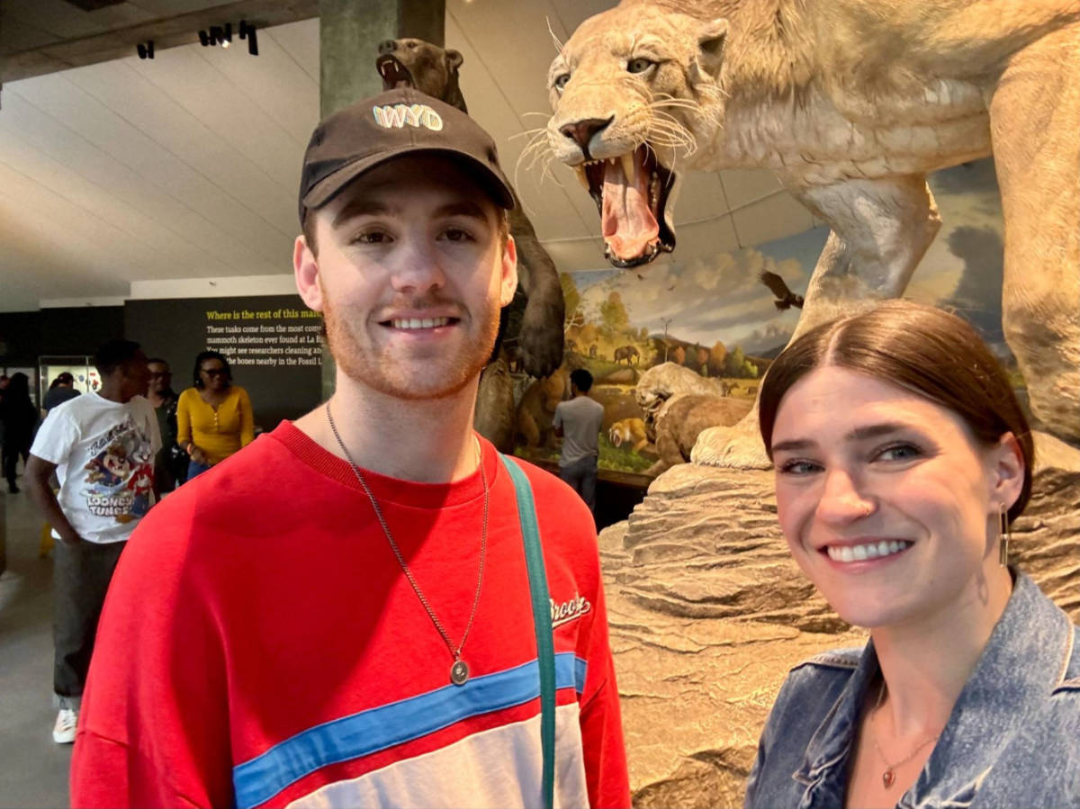 Travel Lemming writer, Betty Hurd and her boyfriend Michael, smiling for a photo in the La Brea Tar Pits museum