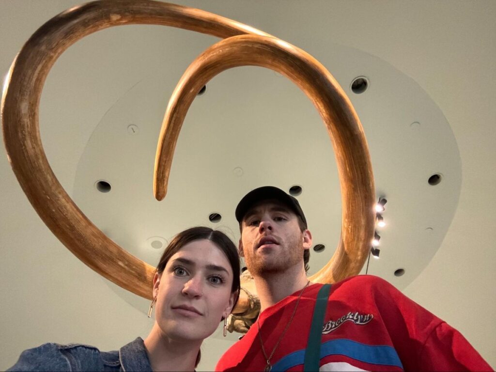 Betty and Michael taking a picture with the mammoth tusk