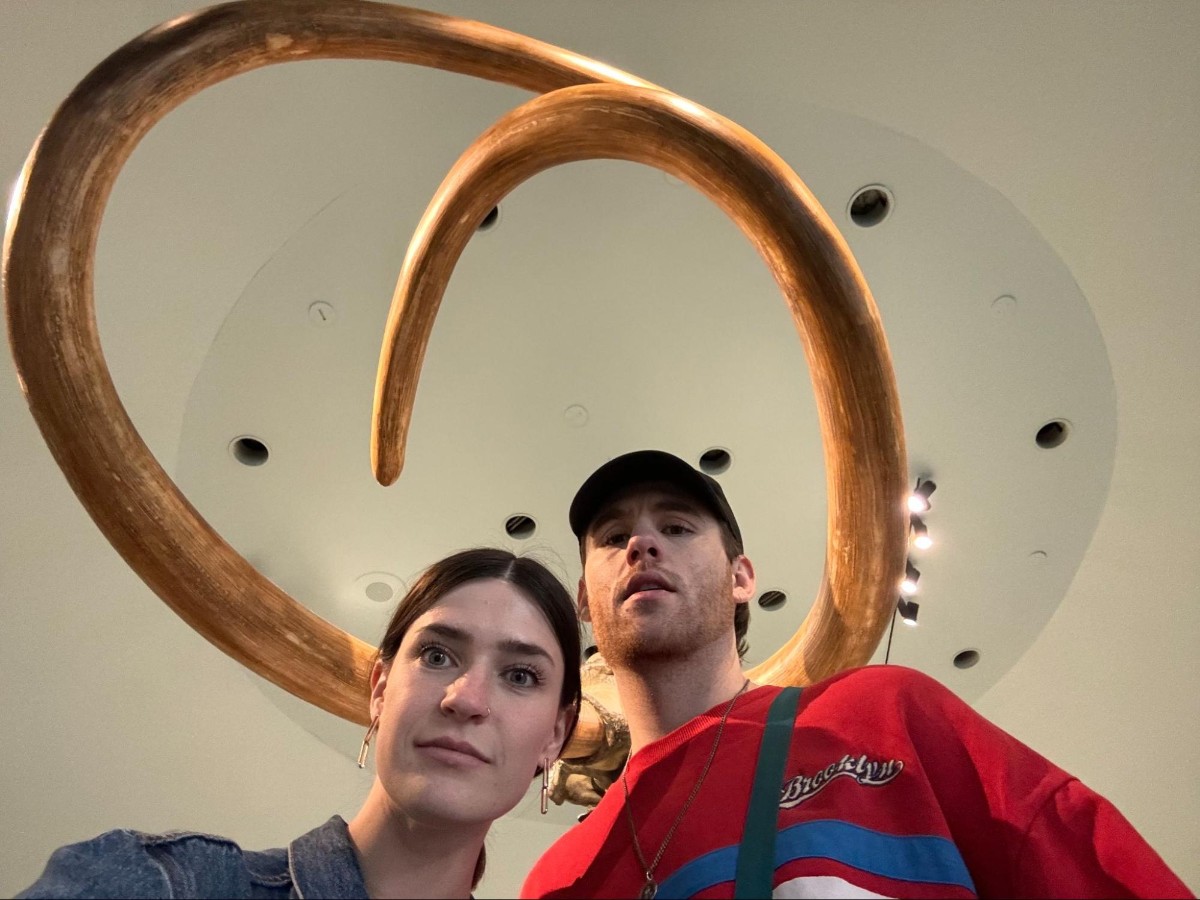 Betty and Michael taking a picture with the mammoth tusk