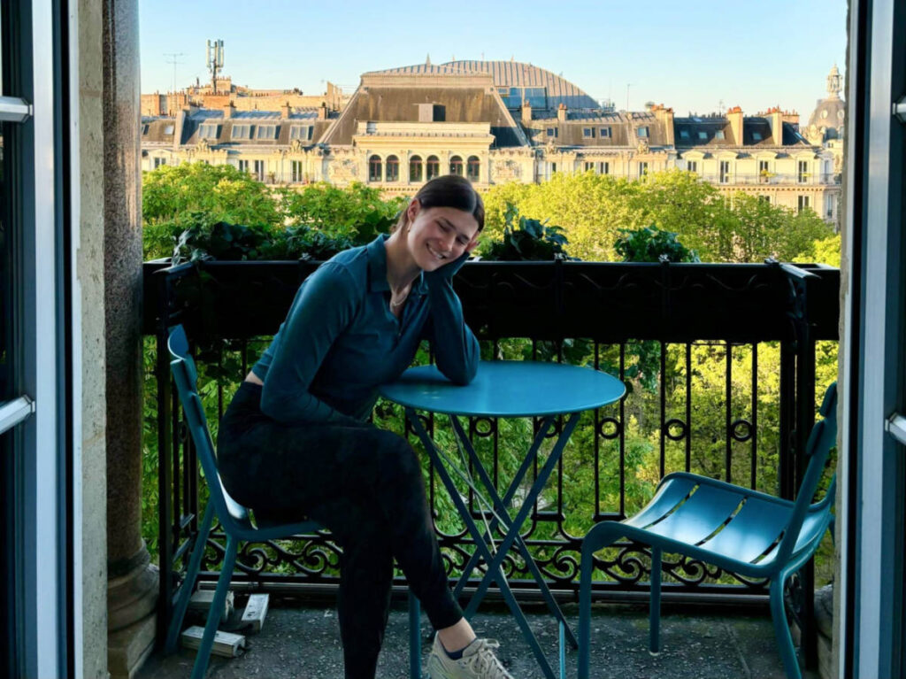 The author Betty Hurd posing for a photo while sitting at the balcony
