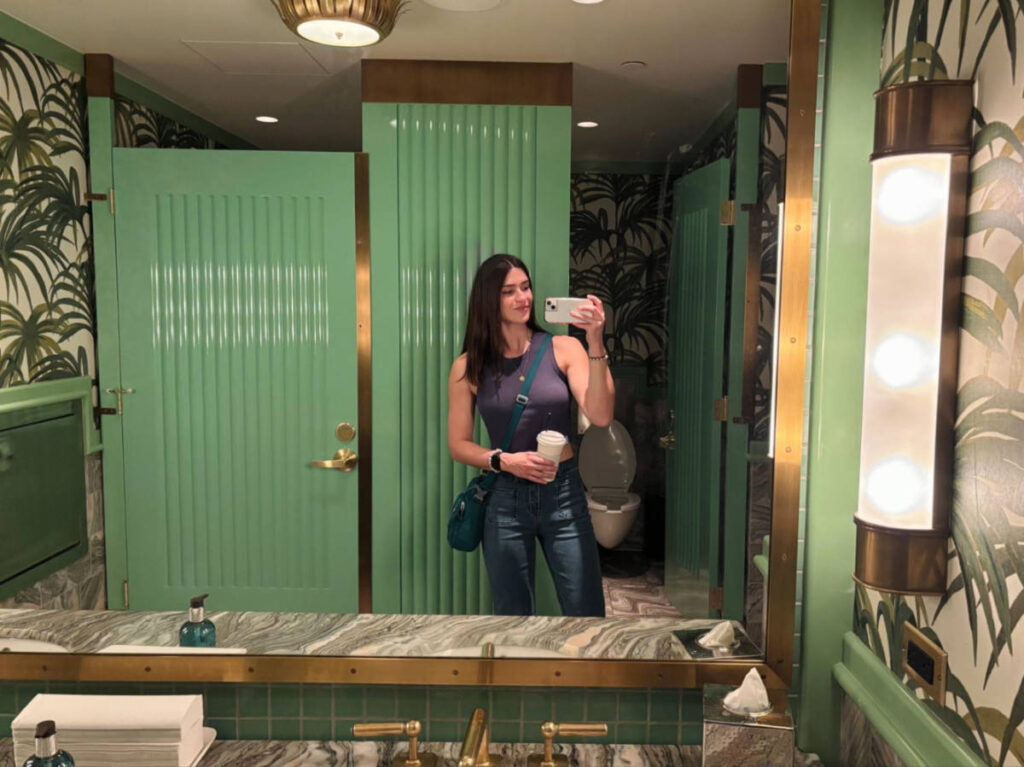 The author Betty Hurd, taking a photo through the mirror in the bathroom lobby of Sun Rose