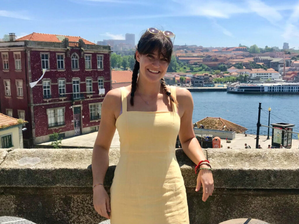 Travel Lemming writer Betty in a yellow dress posing for a photo in Porto, Portugal