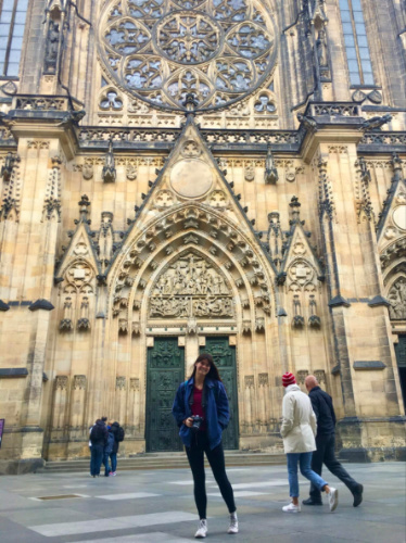 Travel Lemming writer Betty posing in front of a grand cathedral in Prague