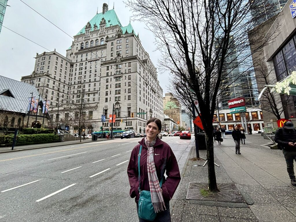 Travel Lemming writer Betty Hurd, smiling for a photo in front of the Fairmont Hotel Vancouver