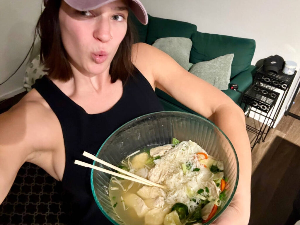 The author Betty Hurd holding a huge bowl of pho from Phở Nhật Restaurant