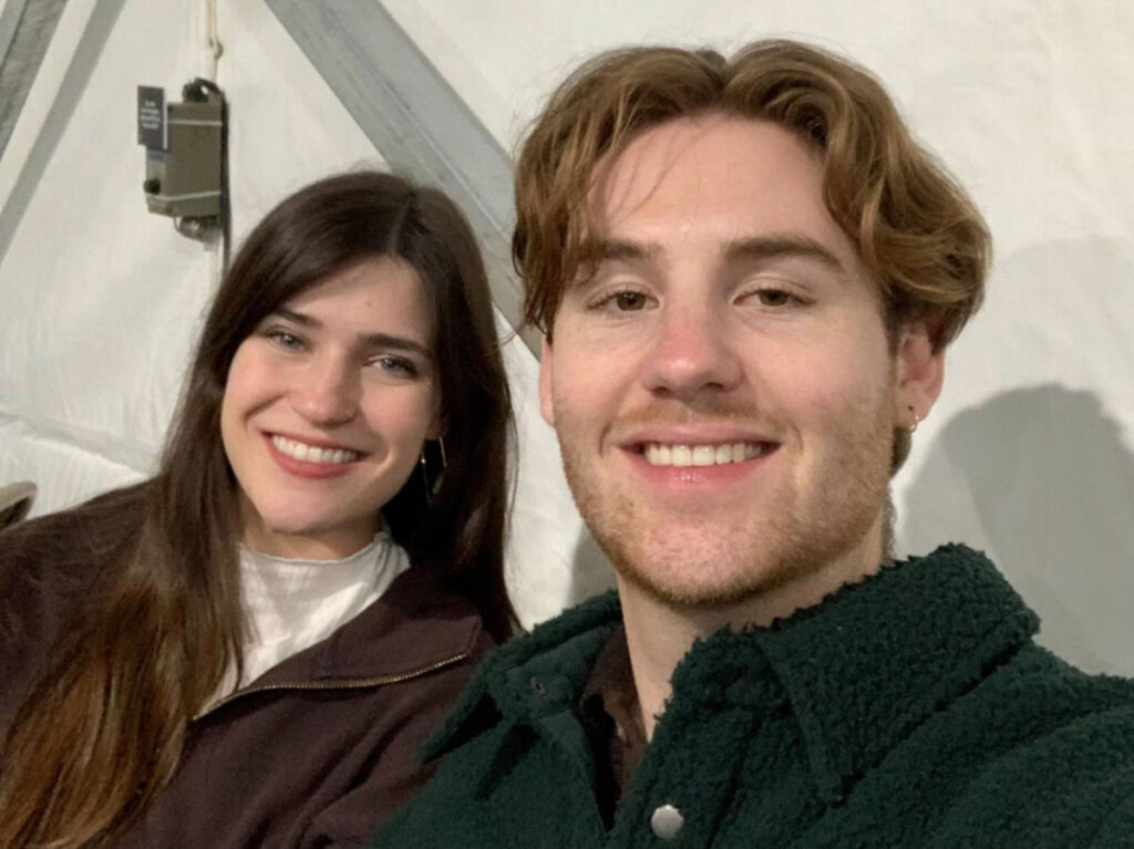 The author Betty Hurd with her boyfriend smiling for a selfie while on a heated tent