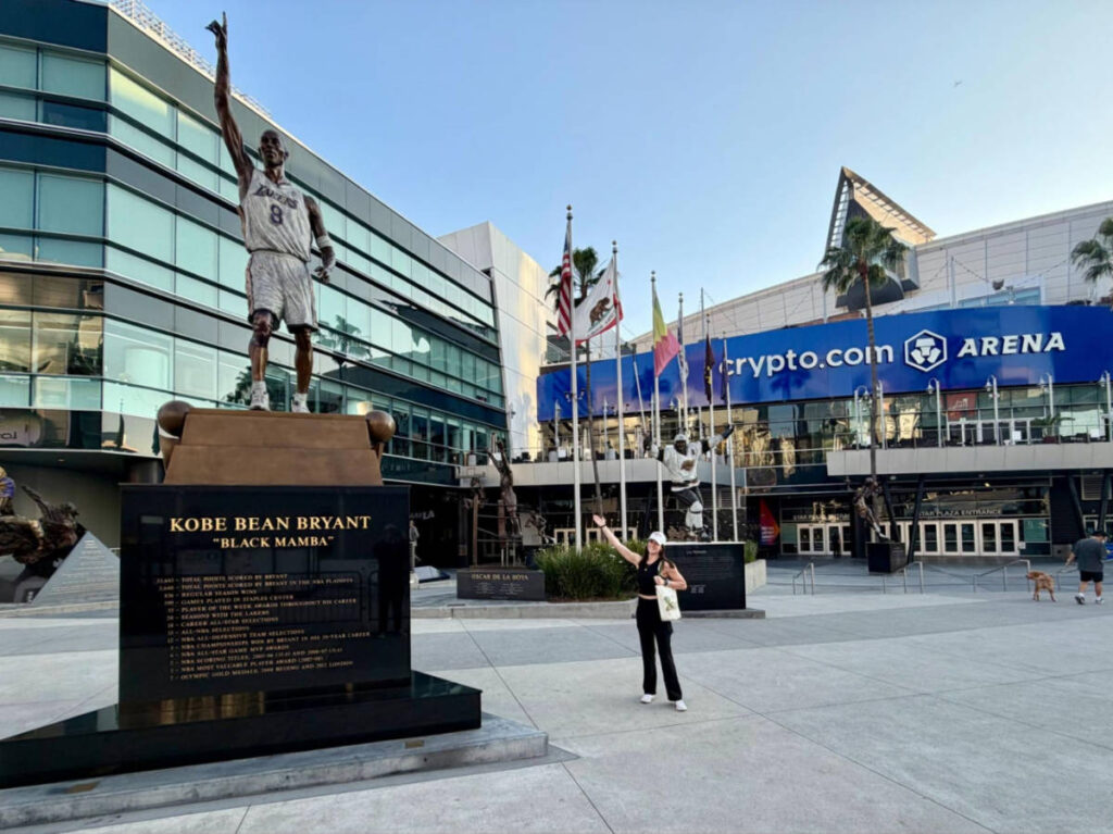 Travel Lemming writer, Betty Hurd, posing for a photo beside the the giant Kobe Bryant statue