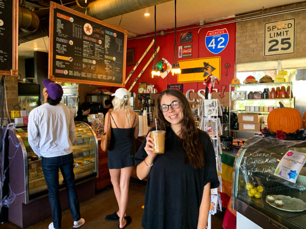 The author's friend holding a cup of coffee at Copper Star Coffee