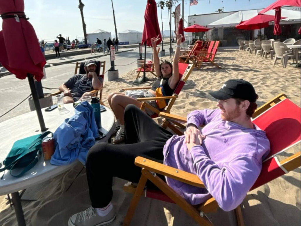 Travel Lemming writer Betty's friends chilling on the lounge chairs at the sandy beach bar