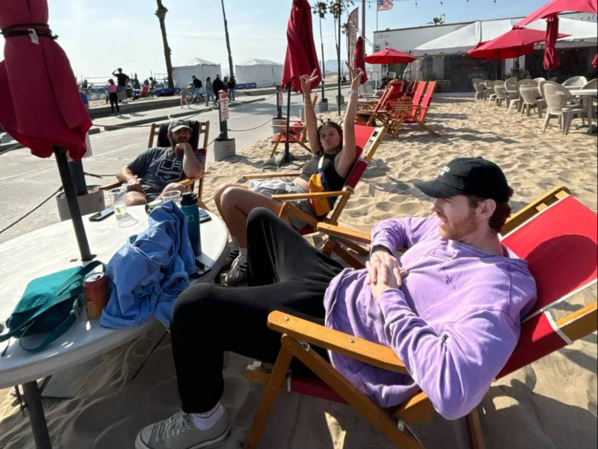 Travel Lemming writer Betty's friends chilling on the lounge chairs at the sandy beach bar