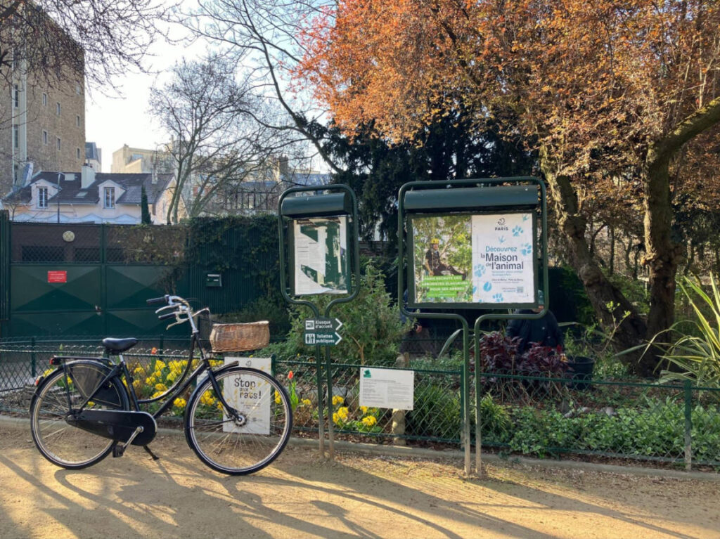 A bicycle parked near the signages in the 16th
