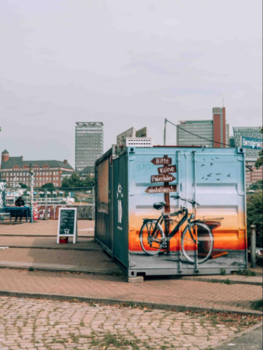 A colorful bicycle mural on an old container van