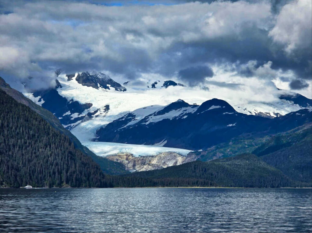 A small ship sailing past the scenic Billings Glacier