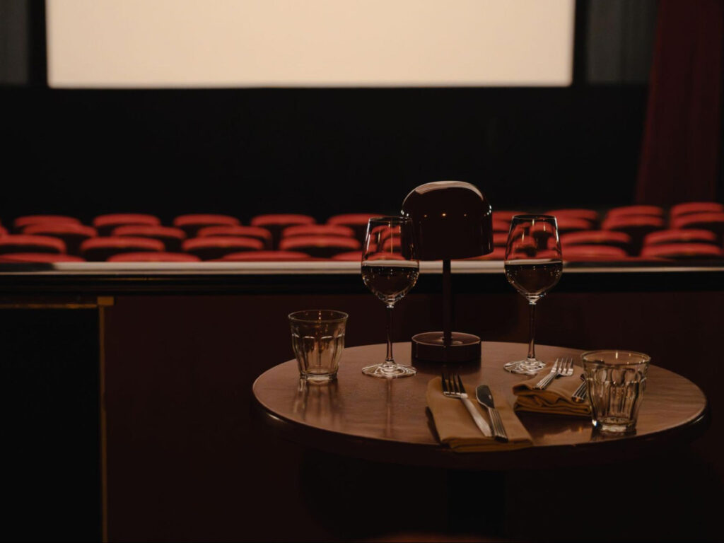 A table with glasses in front of the big screen