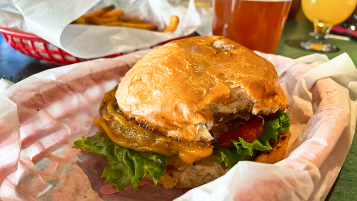 Closeup view of a bitten burger at The Cherry Cricket