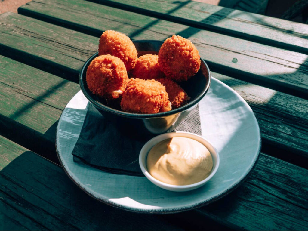 A plate of Bitterballen on a picnic table