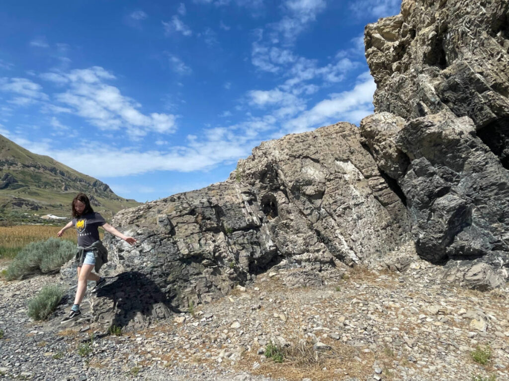 A woman standing in front of a large rock formation at Black Rock Site