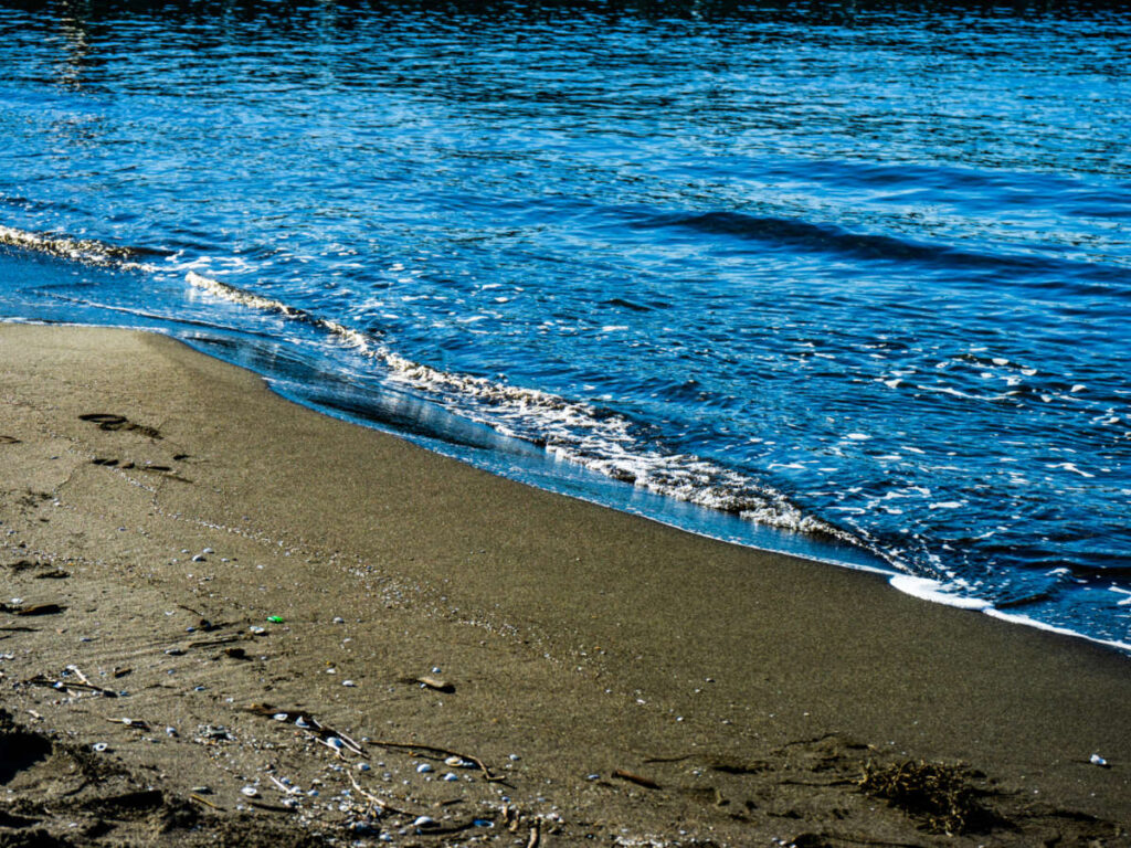 View of the black sand and the deep blue water in Shekvetili