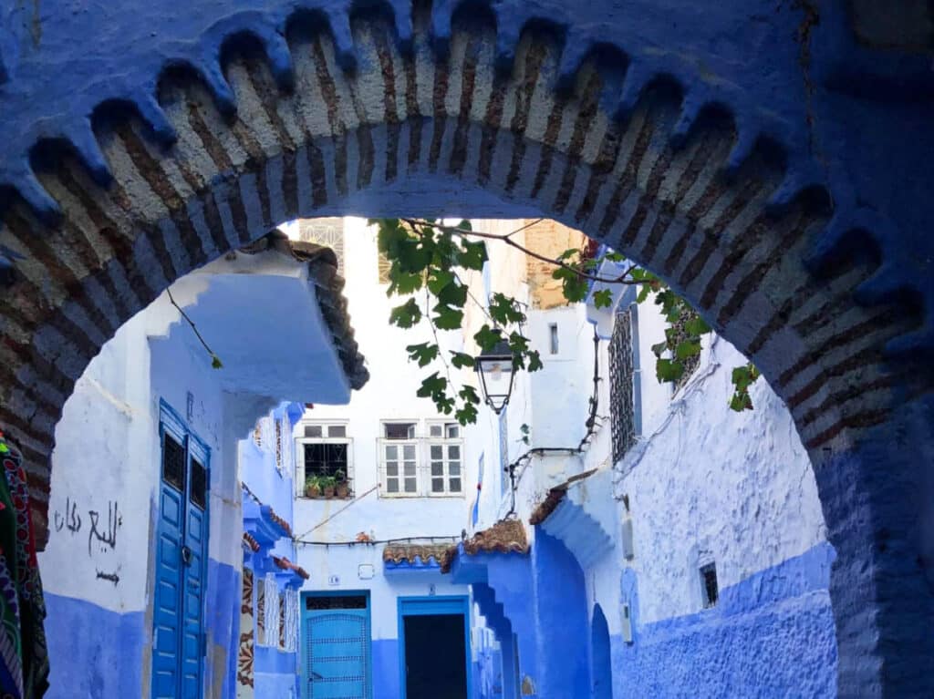 View of the iconic blue streets behind the arch in Chefchaouen