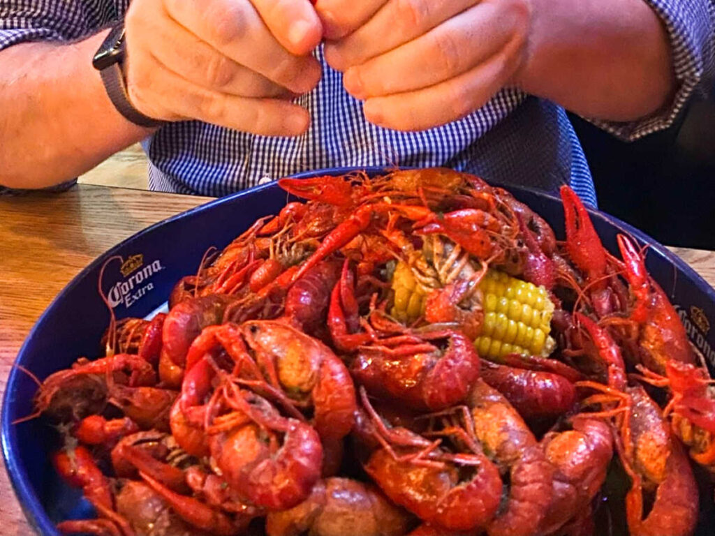A man eating a bowl of Crawfish