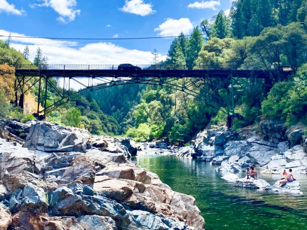 View of the locals swimming on the Yuba River with the bridge in the background
