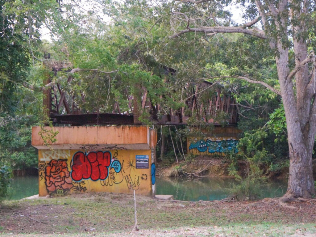 A bridge with colorful graffiti over the Guajataca River