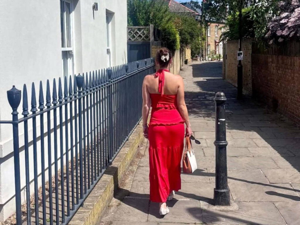 The author Brooke Horrbin, walking along a sidewalk in London
