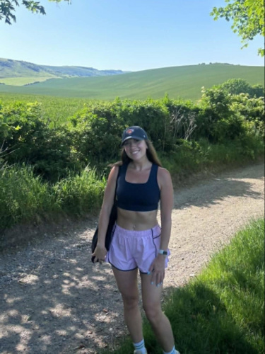 The author Brooke Horrobin, smiling for a photo at the trail to South Downs National Park