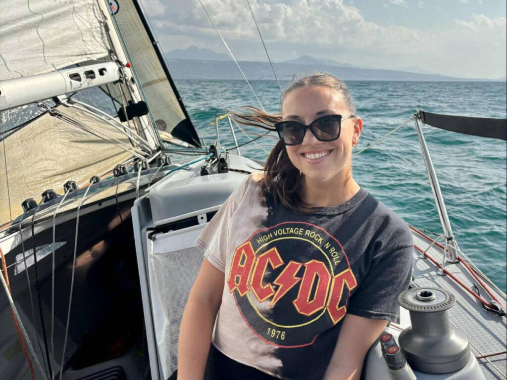 The author Brooke Horrobin, smiling for a photo while sailing on the boat