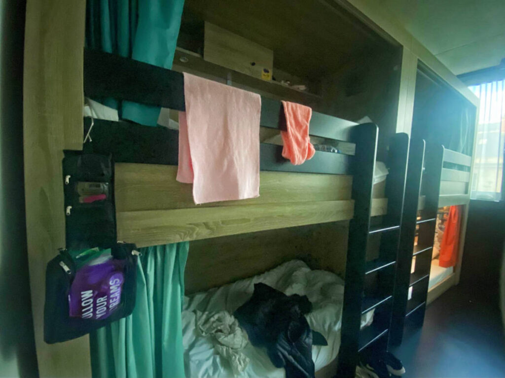 A toiletry bag hanging on a bunk bed
