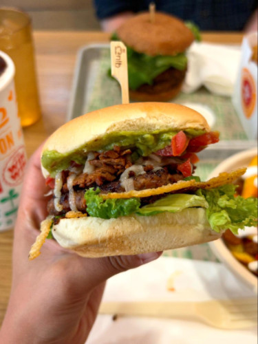 Holding a Veggie Burger at Next Level Veggie Grill