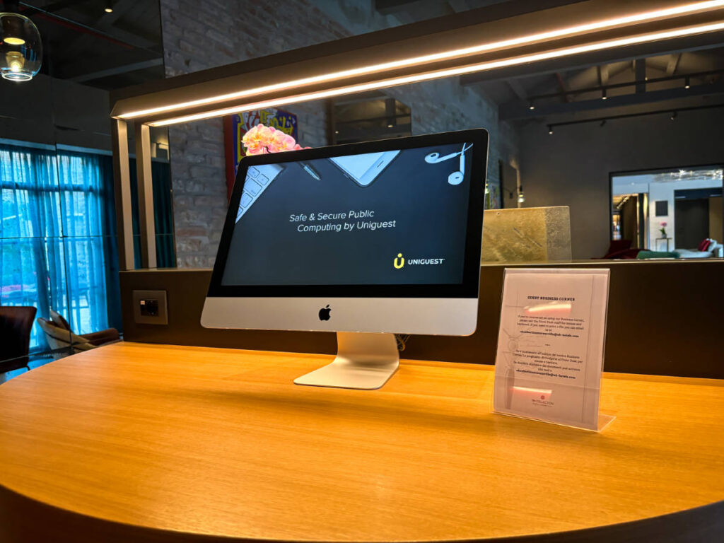 An iMac on the wooden table at the business center of NH Collection Murano Villa