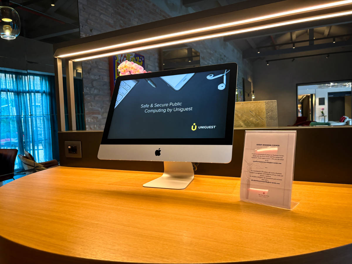 An iMac on the wooden table at the business center of NH Collection Murano Villa