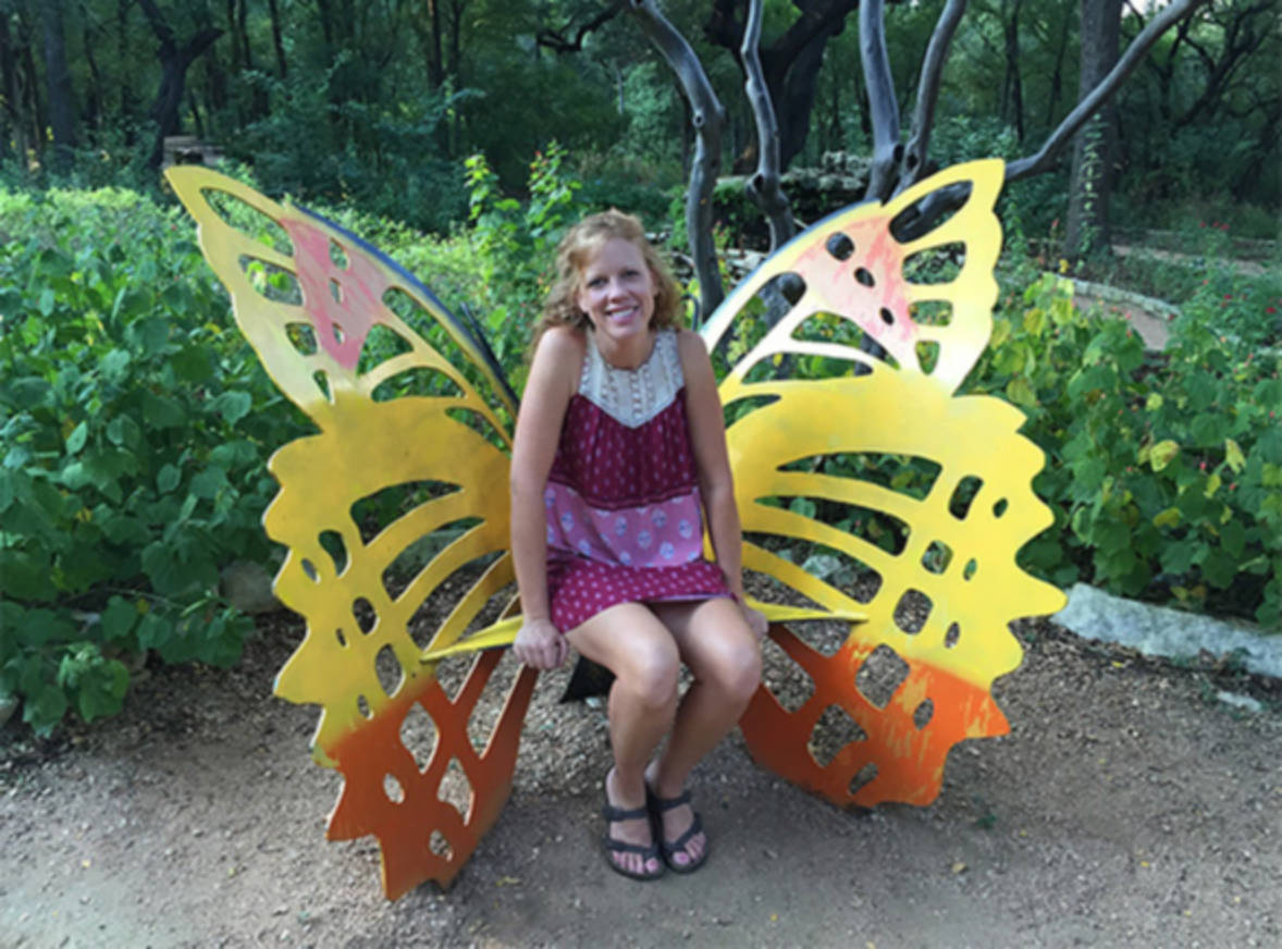 A lady sitting in the Butterfly chair at Zilker Botanical Garden