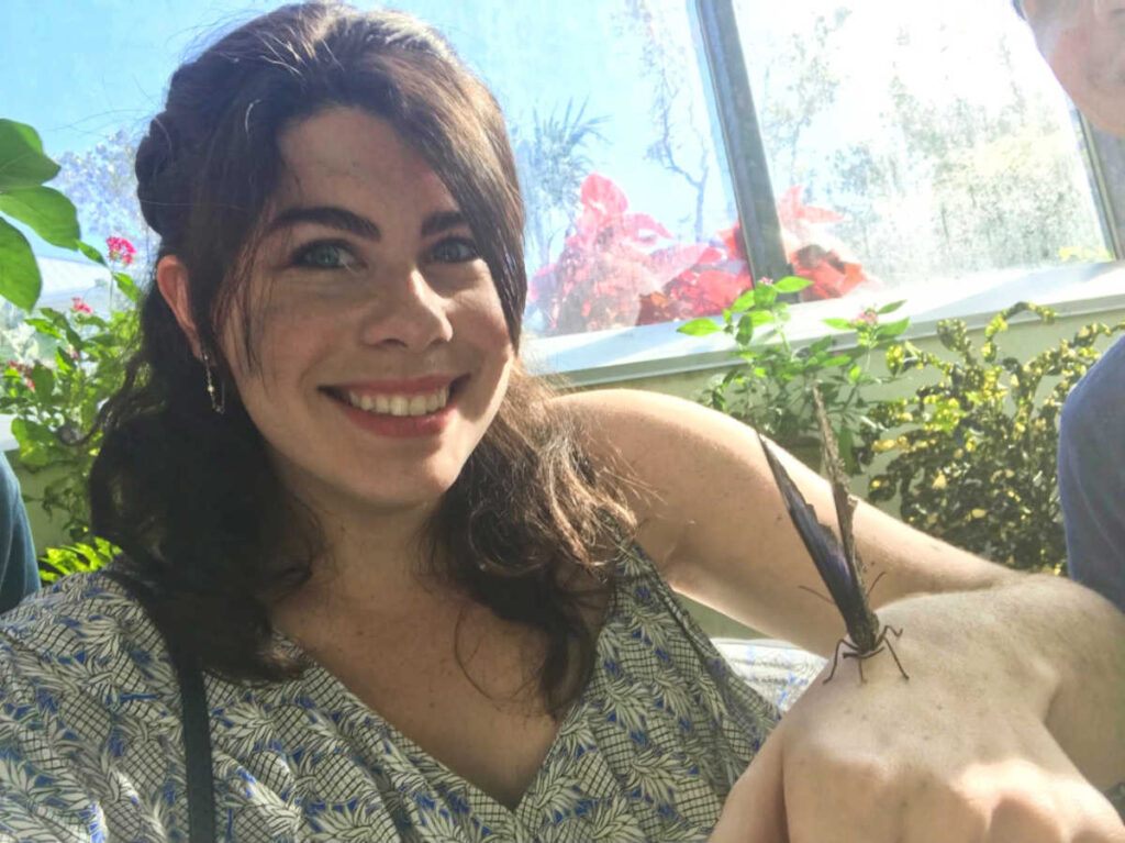 A butterfly landed on the hand of the author Natalie Becerra