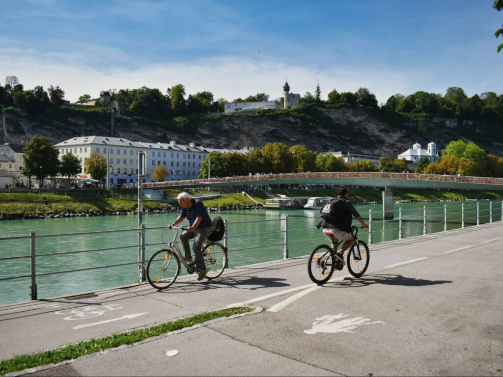 People cycling along the Salzach River