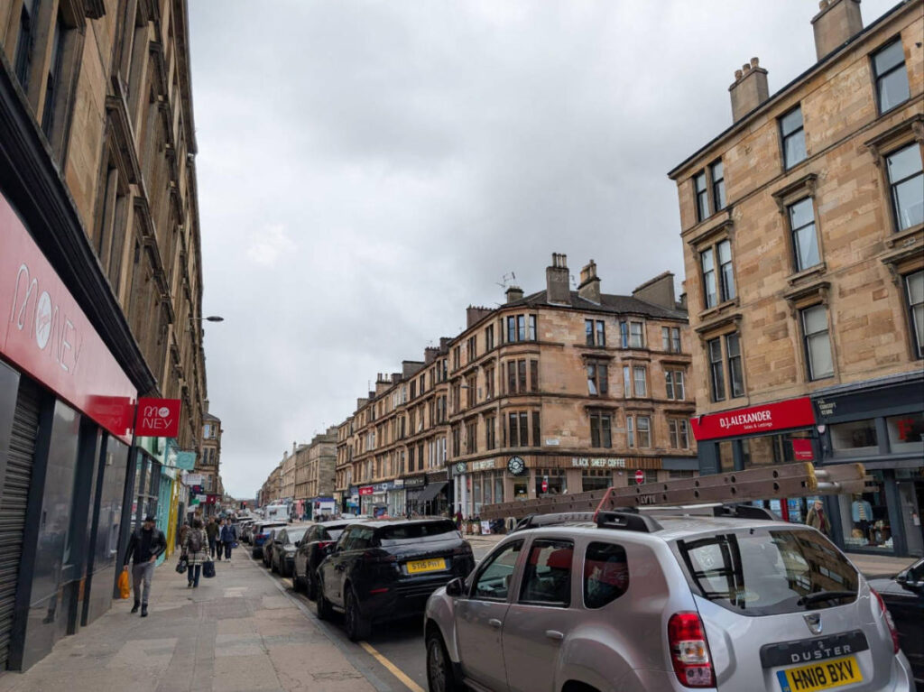 Cars parked on a street parking on Byres Road in Glasgow