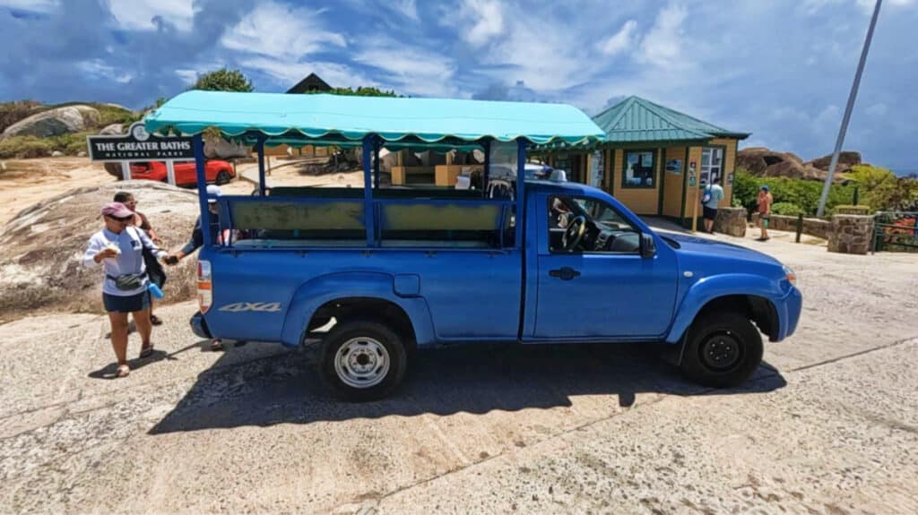 Tourists riding the blue cab going to The Baths