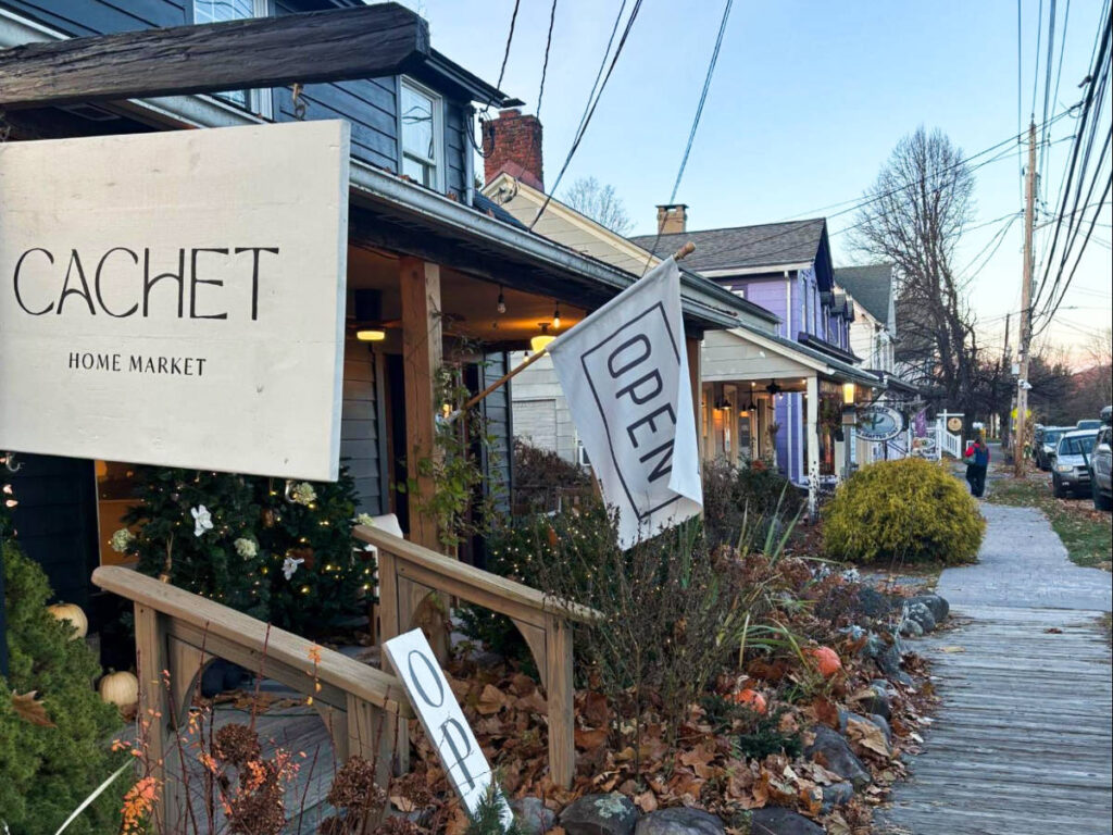 View of the sidewalk and the Cachet Home Market signage outside