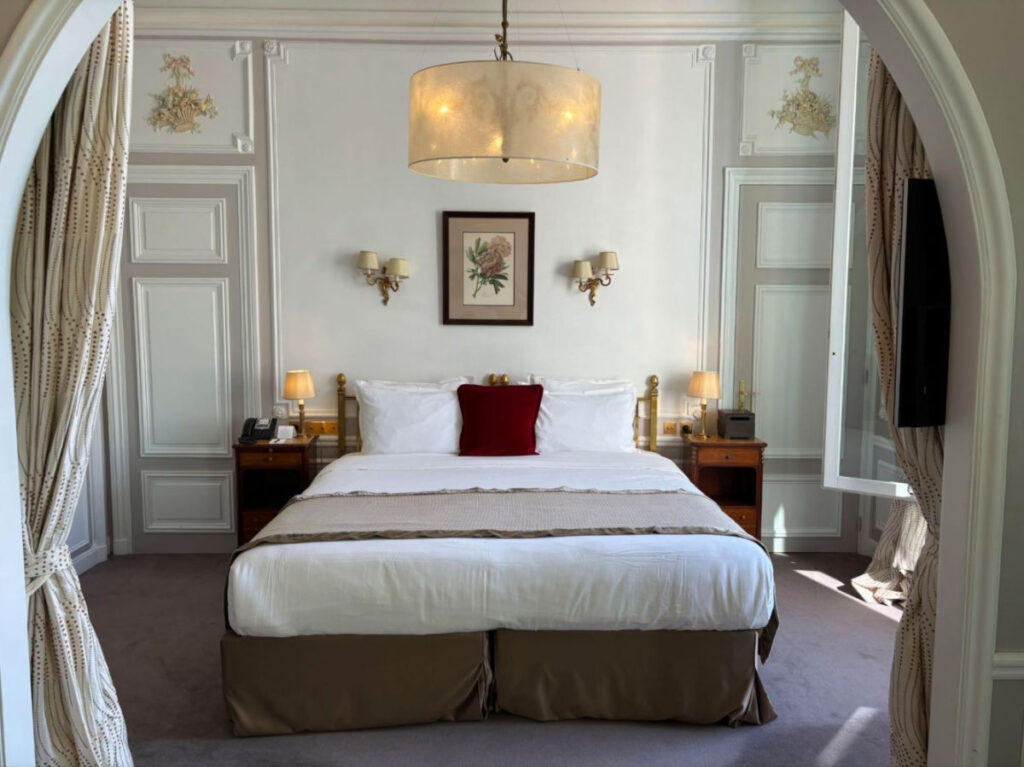 A California King bed at Hotel Regina Louvre